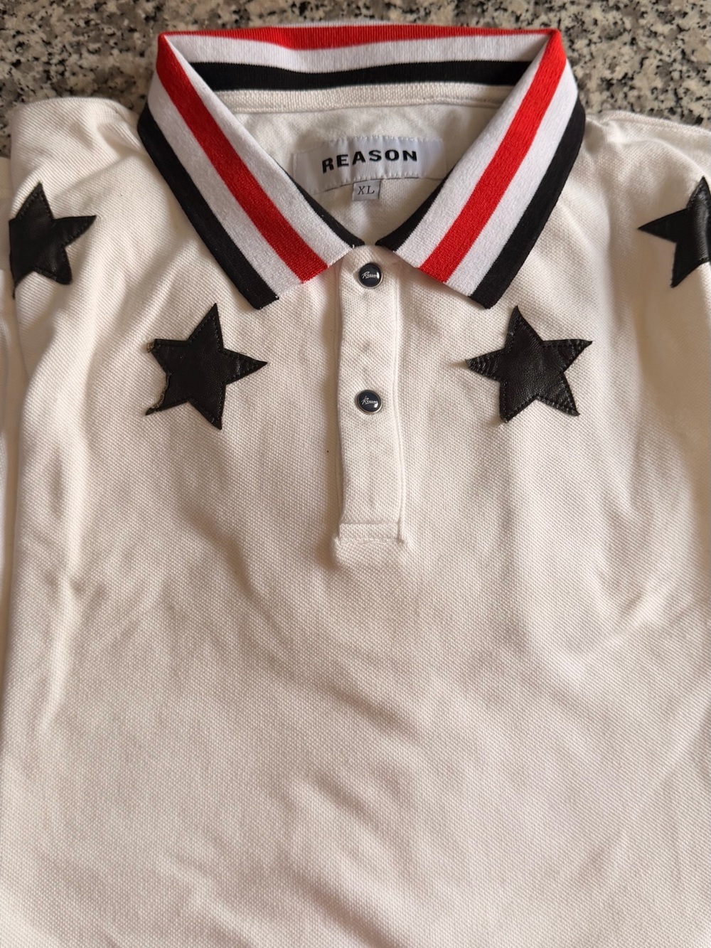 REASON White Polo with Black Star Appliqués and Red-Striped Collar